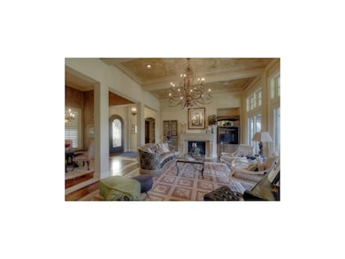 Liv rm boasts soaring ceilings, fireplace & built-
