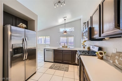 Kitchen featuring light tile floors, appliances wi