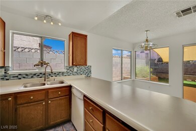 Kitchen with white dishwasher, a chandelier, decor