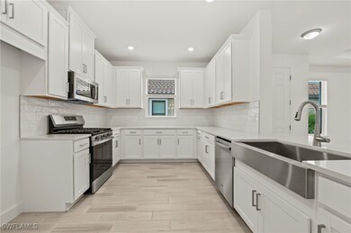 Kitchen with stainless steel appliances, a sink, w