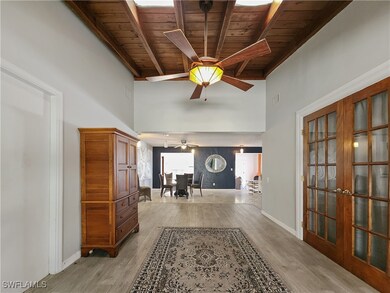 Hall with beamed ceiling, light wood-type flooring
