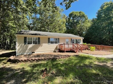 Back of house featuring a wooden deck