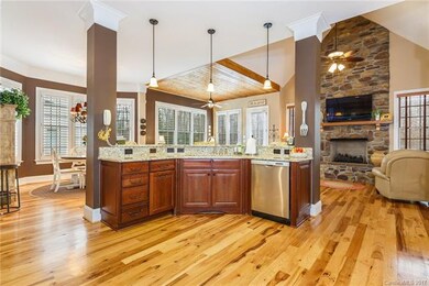 Spacious Kitchen with Island & Stone Fireplace