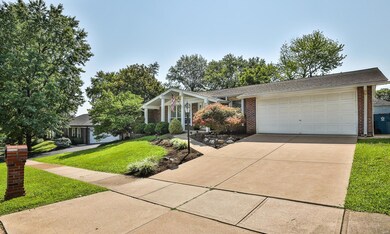 Concrete driveway leads to the 21x19 two car Garage with door opener, overhead light and shelving for storage.