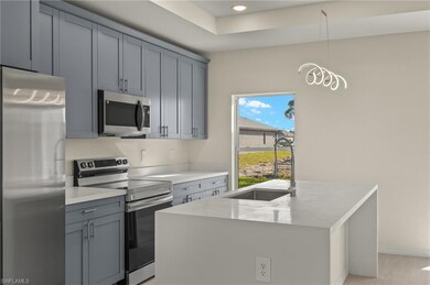 Kitchen featuring decorative light fixtures, sink,