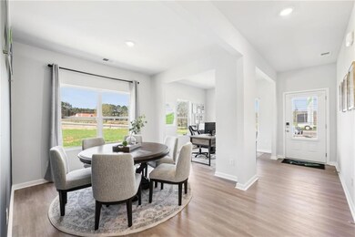 Dining room with wood finished floors, visible ven