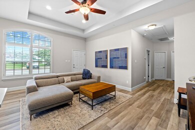 Living area featuring attic access, ceiling fan, 