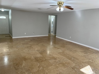 Living room leading to the main entrance (Left)  and bedrooms (right)