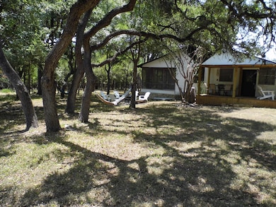 View of green lawn featuring a sunroom and a deck