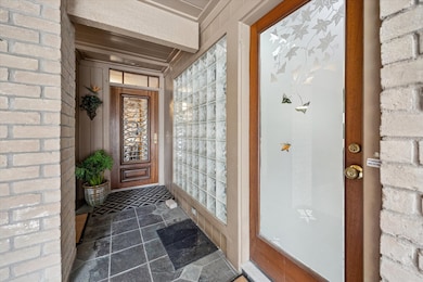 The welcoming entrance features two doors: one on