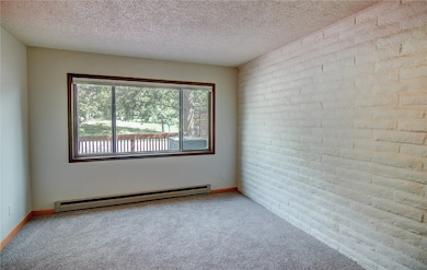Carpeted Living room featuring baseboard heating