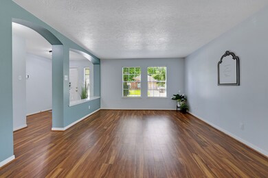 This inviting living space features sleek vinyl pl