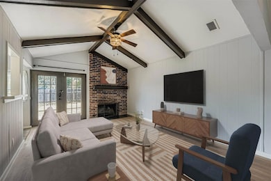 Living area with wood finished floors, a fireplac