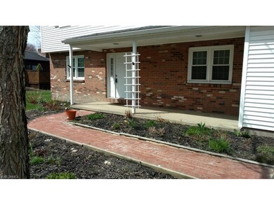 The paverstone front walkway leads to the cement c