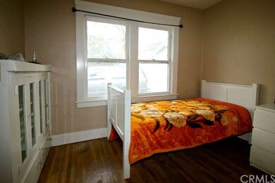 Middle bedroom with original hardwood floors and o