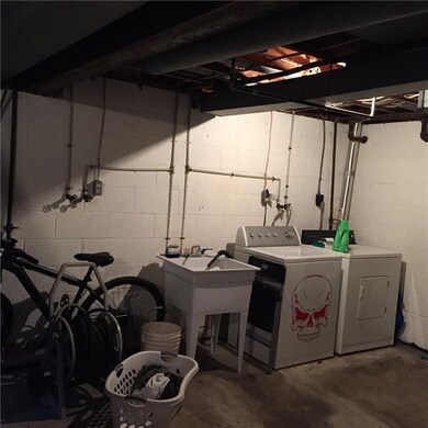 The full basement hosts an area for laundry and pl