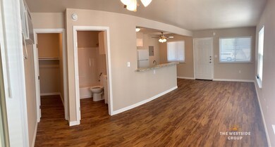 Kitchen with dark wood-style flooring, baseboards