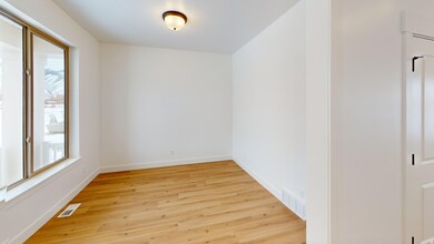 Empty room with light wood-type flooring and baseboards