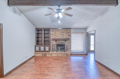 Living room features wood/gas fireplace and built 