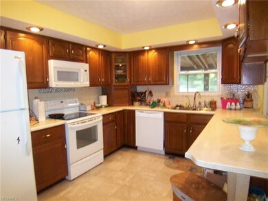 Kitchen has lots of cabinets and plenty of light!