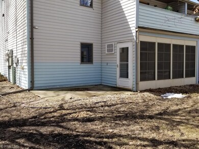 Back of condo-sunroom and patio