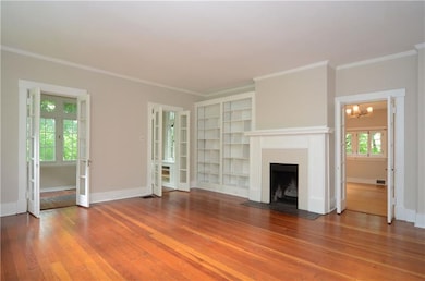 Grand living room features built-in book cases, fi