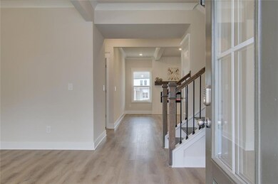 Entryway featuring wood finished floors, stairway, and baseboards