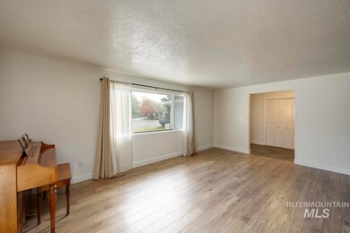 Unfurnished living room featuring a textured ceiling and light wood finished floors
