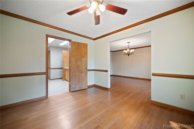 Wood floored empty room featuring a textured ceili
