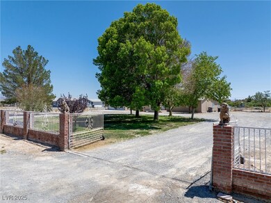 View of dirt / gravel road with a gate and a gated