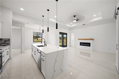 Kitchen featuring a sink, dishwasher, a raised cei