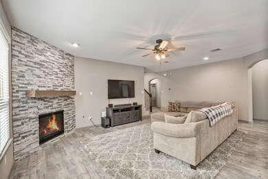 The large family room features a beautiful stone f
