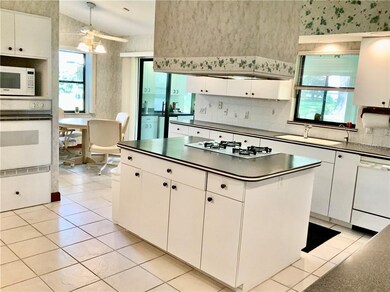 Looking into open kitchen with gas stove top centr