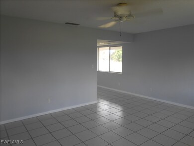 Empty room featuring a ceiling fan, visible vents,
