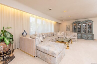 Large living room with recessed and soffit lightin