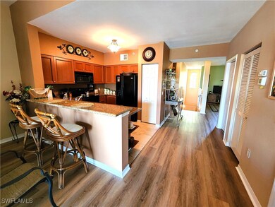 Kitchen with kitchen peninsula, black appliances,
