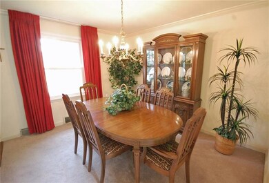 Formal dining room with hardwood under the carpets