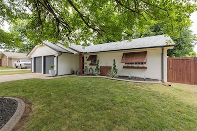 Ranch-style home featuring brick siding, driveway, a garage, and a shingled roof