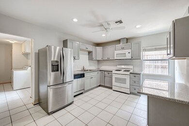 Kitchen with gas range and granite countertops; ut