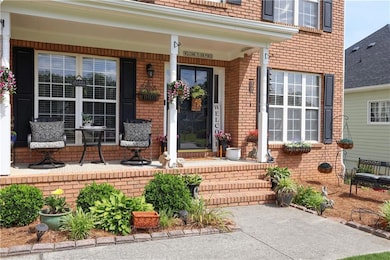 View of exterior entry with a porch and brick sidi