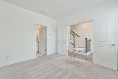 Empty room featuring carpet flooring, visible vent