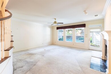 Unfurnished living room with ceiling fan, ornament