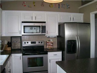 Kitchen with White Cabinets and Stainless Applianc