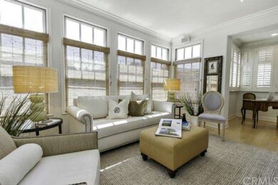 The living room has walls of windows, pretty windo