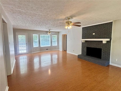 Unfurnished living room featuring wood finished fl
