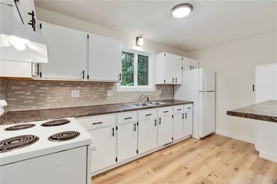 updated flooring, freshly painted cabinets.