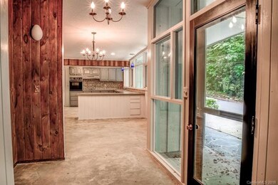 Entry hall. View of kitchen and dining area.