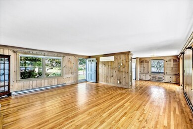 Living toward front door and dining