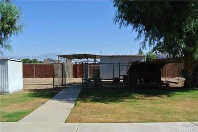 Backyard with 3 storage sheds