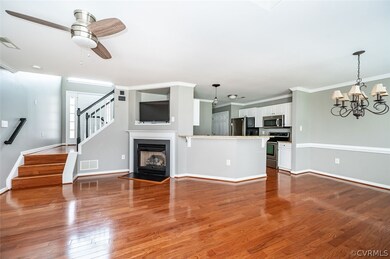 Open plan living room featuring crown molding, woo